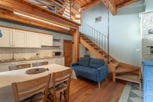 a kitchen and dining room with a table and a blue chair at Civico 8 in Marmora
