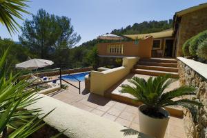 a house with a swimming pool and a resort at Villa Magdalena in Calvià