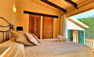 a bedroom with a bed with a dog laying on it at Villa Magdalena in Calvià +31 photos