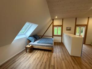 a bedroom with a bed in a room with a window at Ferienwohnung Derday im Schuttertal in Schuttertal