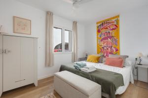 a bedroom with a bed and a painting on the wall at Casa Golf in Son Parc