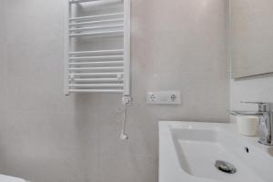 a white bathroom with a sink and a mirror at Casa Golf in Son Parc +25 photos
