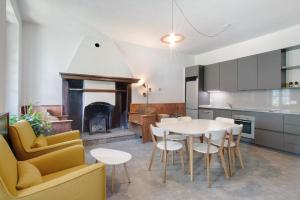 a kitchen and dining room with a table and a fireplace at Workation Castle - Casa Galbiga in Carlazzo