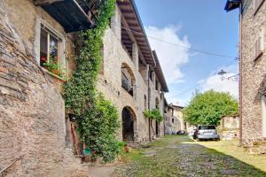 an alley with ivy on the side of a building at Workation Castle - Casa Galbiga in Carlazzo