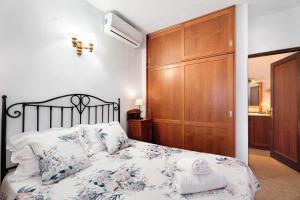 a bedroom with a bed and a wooden cabinet at Casa Rodri in Puntagorda