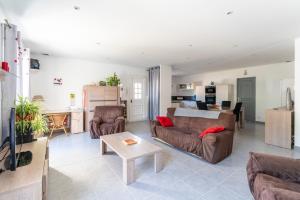 a living room with a couch and a table at Villa de Maithe, clim, terrasse in Sernhac