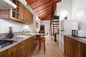 a kitchen with wooden cabinets and a white refrigerator at Casa Rodri in Puntagorda