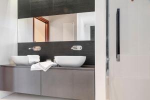 a bathroom with two sinks and a mirror at Villa Luna Al Lago in Biandronno +30 photos
