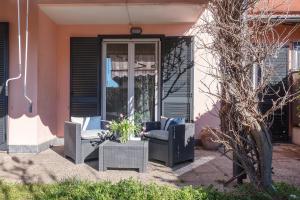 a patio with two chairs and a table at Villa Luna Al Lago in Biandronno