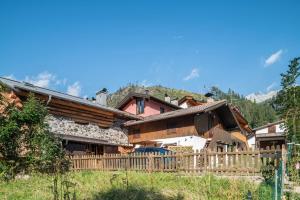 a wooden fence in front of a house at Ciasa de Lucky in Moena