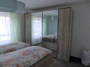 a bedroom with two beds and a mirrored closet at Ferienwohnung Seepferdchen in Heiligenhafen