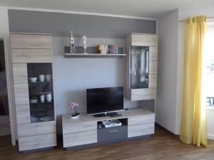 a living room with a large entertainment center with a tv at Ferienwohnung Seepferdchen in Heiligenhafen