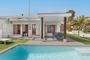 a villa with a swimming pool and a house at Casa-piscina privada en Vallpineda in Sant Pere de Ribes