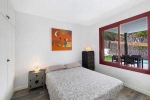a bedroom with a bed and a window at Casa-piscina privada en Vallpineda in Sant Pere de Ribes +19 photos