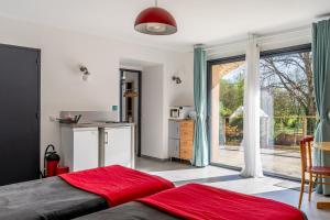 a bedroom with a bed and a large window at Studio L'Erdre au moulin - terrasse in Joué-sur-Erdre