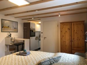 a bedroom with a bed and a kitchen at Good Habits in Kleinengstingen