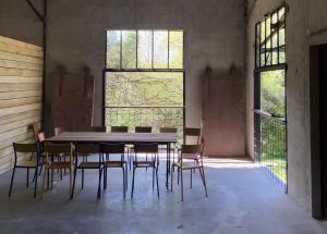 a table and chairs in a room with two windows at Studio L'Erdre au moulin - terrasse in Joué-sur-Erdre