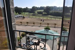 a balcony with a view of a horse field at Gîte De La Haie Bourgère in Moulay +14 photos