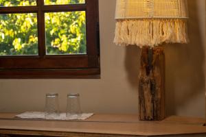 a table with two glasses and a lamp on it at PHOENIX maison d'hôtes & SPA in Ginasservis +38 photos