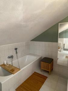 a bathroom with a large tub and a shower at Gutsherren Räume in Groß Upahl +37 photos