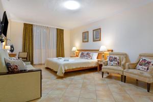 a hotel room with a bed and two chairs at Villa Private Pool Los Cristianos in Los Cristianos +26 photos