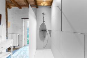a white bathroom with a shower in a room at Gite La Ferme En Sud Charente in Montboyer