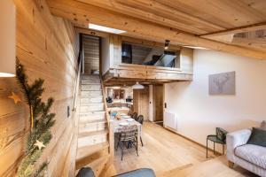 a room with wooden walls and a table and chairs at L'alpin in Les Déserts