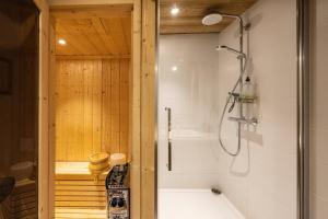 a bathroom with a shower and a tub at L'alpin in Les Déserts +18 photos