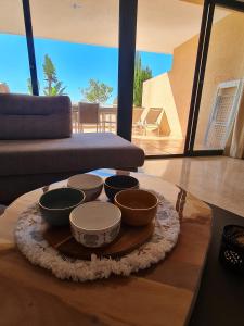 a tray with bowls on a table in a living room at Altea La Nova in Bernia