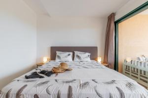 a bedroom with a bed with a hat and shoes at Altea La Nova in Bernia +34 photos