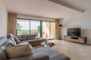 a living room with a couch and a flat screen tv at Altea La Nova in Bernia