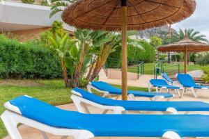 a group of blue and white chairs and an umbrella at Altea La Nova in Bernia