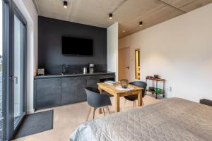 a bedroom with a bed and a table with chairs at Apartment Schlossterrassen 4a in Pouch +10 photos