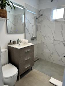 a bathroom with a shower and a toilet and a sink at Chalet Mar Y Montaña in Los Silos +36 photos