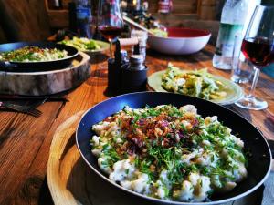 a table with a bowl of food and plates of food at Allgäu Fewo Hüttenflair Bergblick in Bad Hindelang +17 photos