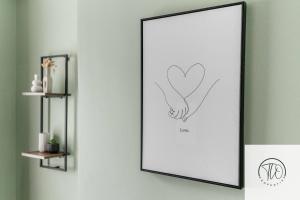 a framed picture of a hand holding a heart at Shamrock House in Ipswich