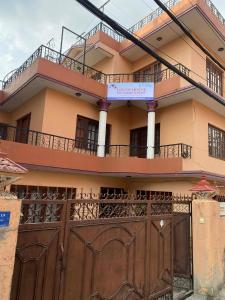a building with a gate and a fence at Logos House Nepal in Pātan