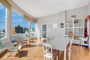 a dining room with a white table and chairs at Casa del Pescador 2 in Santa Cruz de Tenerife