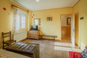 a bedroom with a bed and a dresser and a window at San Pelayo in San Millán de Lara