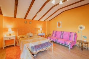 a bedroom with a bed and a couch at San Pelayo in San Millán de Lara +22 photos