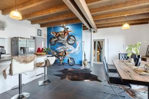 a dining room with a mural of motorcycles on the wall at Deluxe Loft Hegau Bodensee in Hilzingen