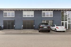 two cars parked in front of a building at Deluxe Loft Hegau Bodensee in Hilzingen