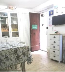 a bedroom with a table and a dresser and a door at Casa vacanza La Mia Casetta Sutri Centro Storico in Sutri