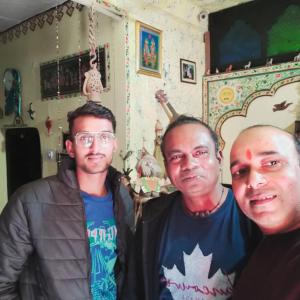 three men posing for a picture in a room at Hom stay moon light Pushkar in Pushkar