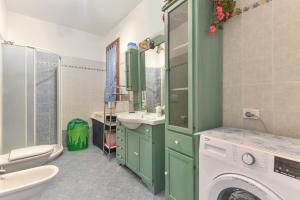a bathroom with a washer and a washing machine at Appartamento Orchidea in Capoliveri +20 photos