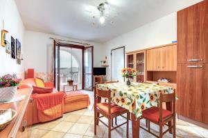 a living room with a table and a couch at Appartamento Orchidea in Capoliveri