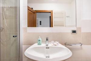 a bathroom with a sink and a shower and a mirror at Chalet Panorama Rabbi By Immobilux in Rabbi +26 photos