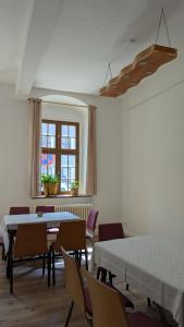 a room with tables and chairs and a window at CVJM Peregrinus Herberge in Görlitz