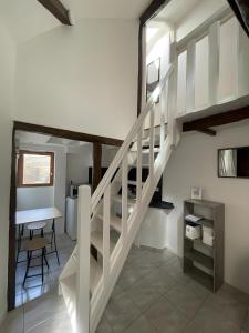 a staircase in a house with a table and a desk at Logement Cosy centre Joigny C4 in Joigny