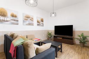 a living room with a couch and a tv at Casa Abuela Nicolasa in Máguez